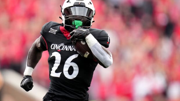 Cincinnati Bearcats running back Myles Montgomery (26) breaks free from Baylor Bears cornerback Chateau Reed (21) on a touchdown run in the second quarter during a college football game between the Baylor Bears and the Cincinnati Bearcats, Saturday, Oct. 21, 2023, at Nippert Stadium in Cincinnati.